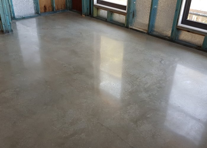 a polished concrete floor which received concrete overlay beforehand