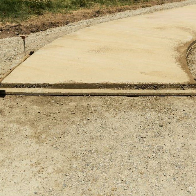 A concrete pathway in the middle of being completed.