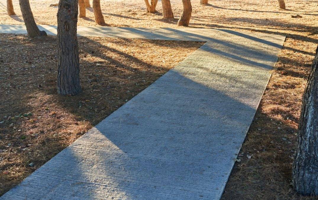 A recently completed concrete path in a public park.