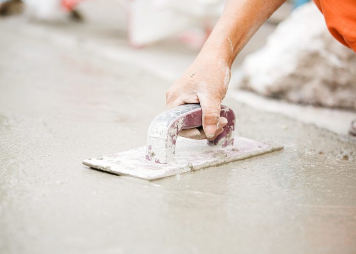 smoothing out a freshly laid concrete floor