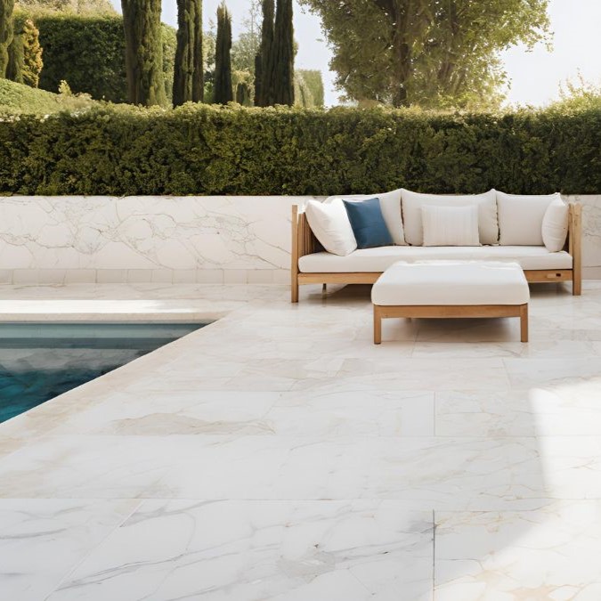 Marble flooring outside for a seating area and pool.