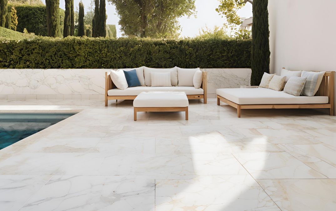 Marble flooring outside for a seating area and pool.