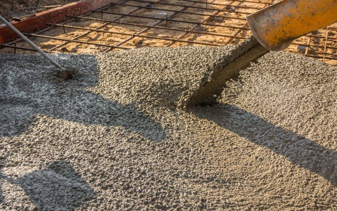 Concrete mix being poured onto sub base.