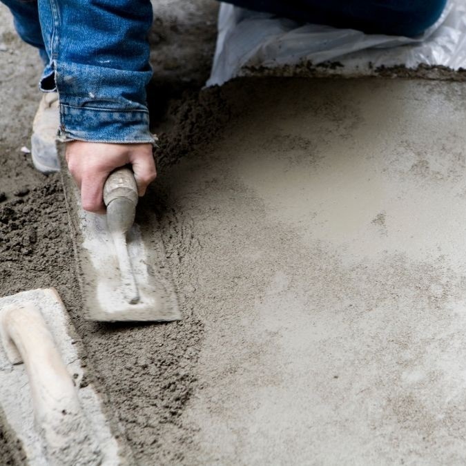 Wet concrete being smoothed with a trowel