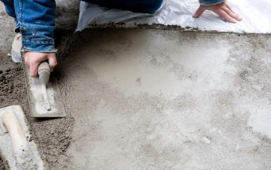 Wet concrete being smoothed with a trowel