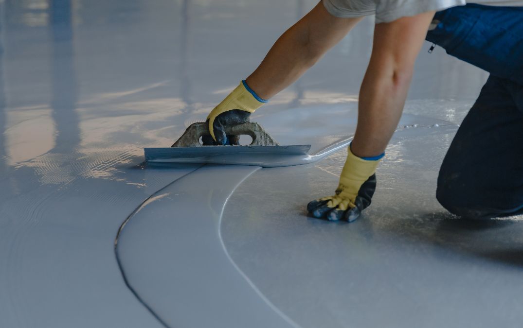 Epoxy resin flooring being smoothed out for a garage.