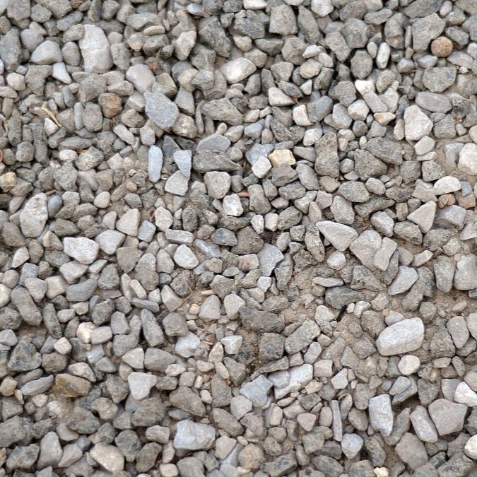 Gravel laid over the top of compressed soil, acting as reinforcement for fresh concrete.