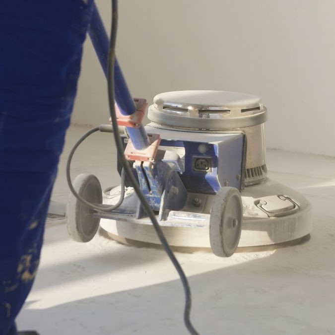 Concrete floor grinder being used to grind concrete floors.