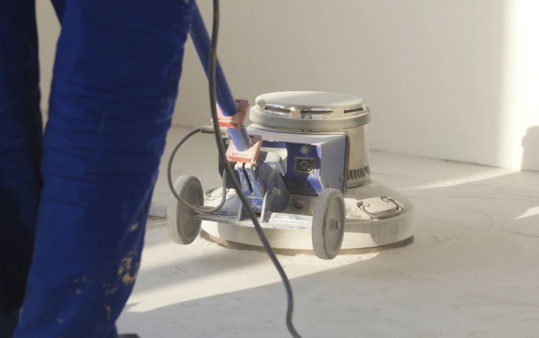 Concrete floor grinder being used to grind concrete floors.