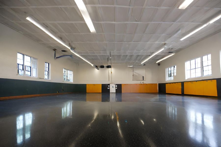 A stunning grey an black exposed-aggregate polished concrete floor in a Bath
          warehouse