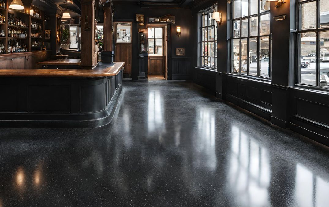 Black aggregate concrete flooring in a pub.