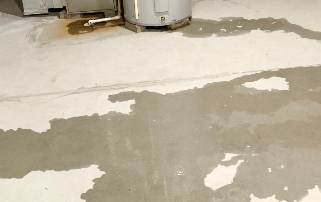 Wet concrete flooring where water has leaked.