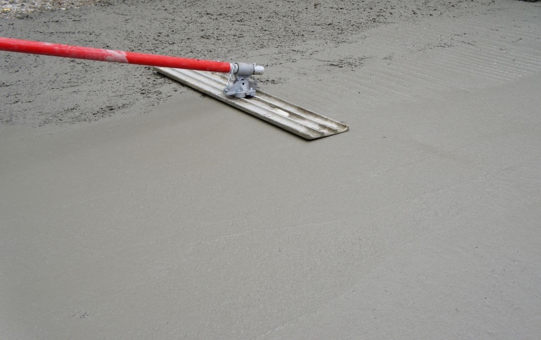 cement being smoothed with a bull float.