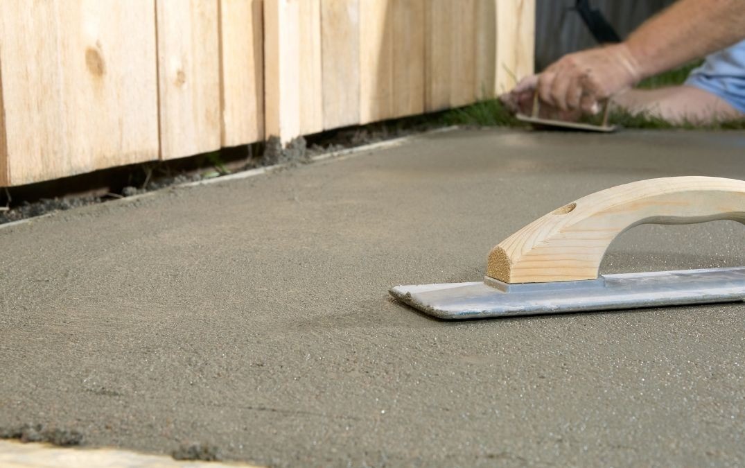 Hand float being used to smooth concrete.