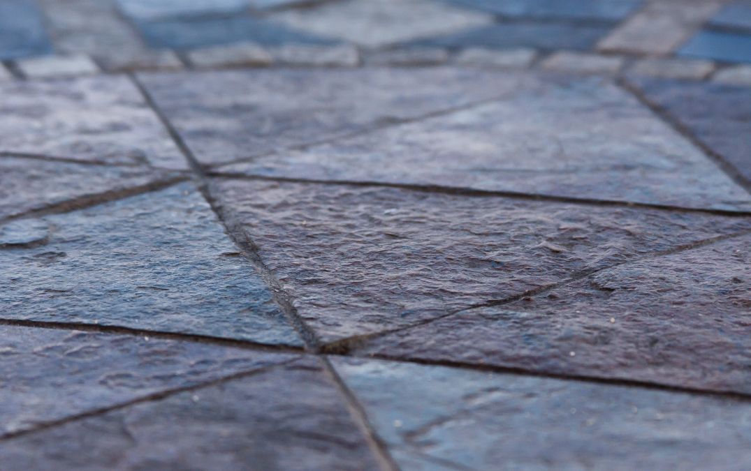 Outdoor slate tiles that have been cut into triangles for flooring.